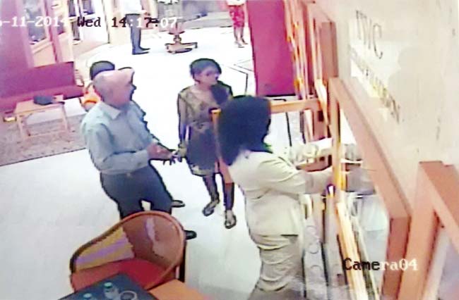 Surendra Punjabi and one of the Pandey sisters in a CCTV grab from the store