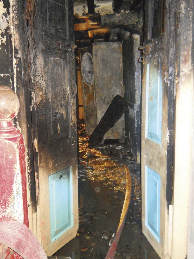 The burnt front door of Qureshi’s house