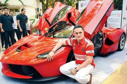 Gautam Singhania strikes a pose with a Ferrari