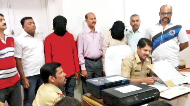 Ashok Mehta and Rajesh Punjabi (hooded) were arrested this week