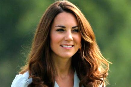 Kate Middleton says her baby kicks all the time