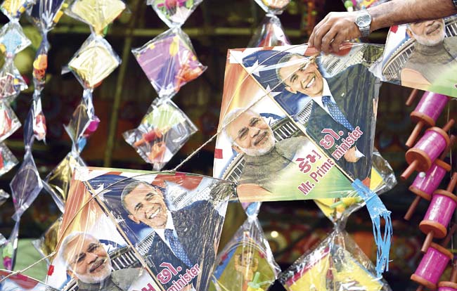A shopkeeper strings kites with images of Narendra Modi (l) and US President Barack Obama (r) in Mumbai. Obama travels to India as chief guest for the January 26, Republic Day celebrations and talks with Prime Minister Modi. Pic/AFP