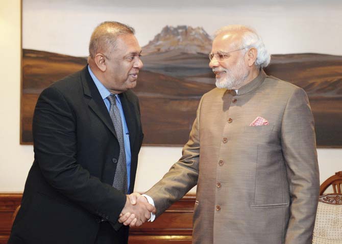 Sri Lankan Foreign Minister Mangala Samaraweera (left) shakes hands with Prime Minister Narendra Modi, during a visit to New Delhi to improve strained ties after elections in the island nation toppled long-time strongman Mahinda Rajapakse. Pic/AFP/PIB