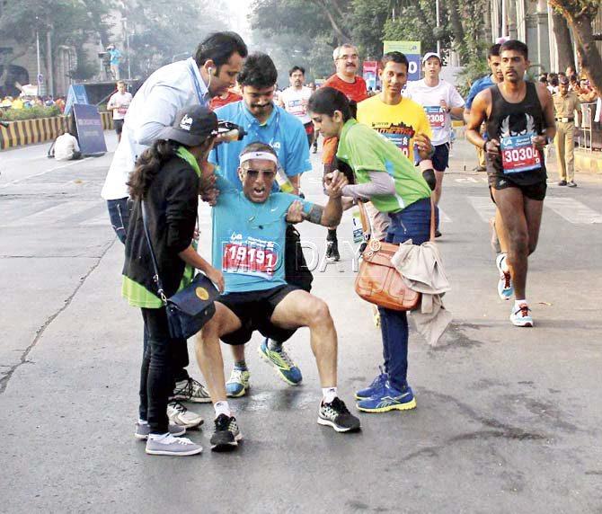 A participant is helped by fellow runners and volunteers. Pic/Sameer Markande