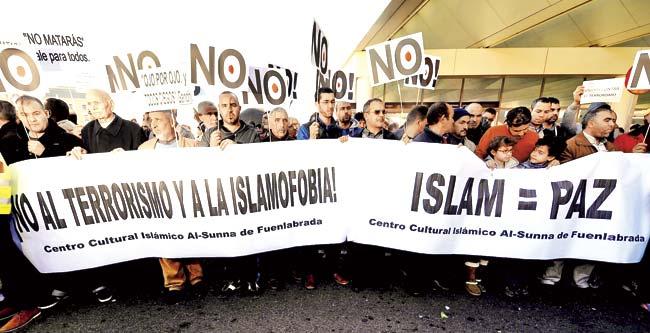 Muslims in Madrid, Spain hold up banners with messages such as ‘No to terrorism and to Islamophobia’ and ‘Islam = Peace’ during a show of solidarity following three days of bloodshed triggered by the attack on the French satirical weekly Charlie Hebdo on January 7. Pic/AFP