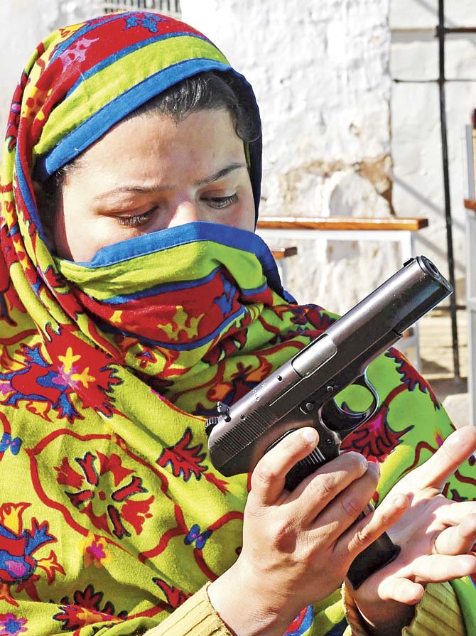 A Pakistani teacher loads a magazine into a pistol during a weapons-training session in Peshawar. Authorities in northwest Pakistan have allowed teachers to carry firearms to school and have begun weapons training for them, in the wake of a Taliban attack on an army-run school in December 2014.  The security situation is so precarious that parents are afraid to send their children to schools, colleges and universities as educational institutions are on high alert. Pic/AFP