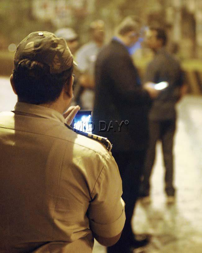A constable takes a photo of Police Commissioner Rakesh Maria on the streets, during a mob violence incident on Sunday night. Pic/Rane Ashish