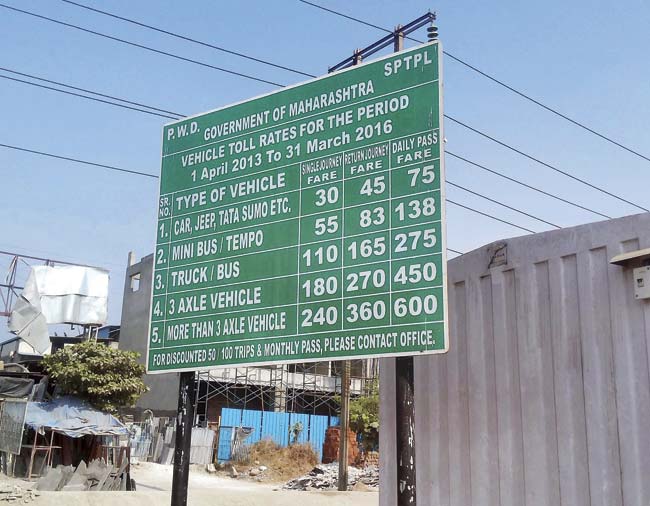 A board displaying the  toll rates for vehicles