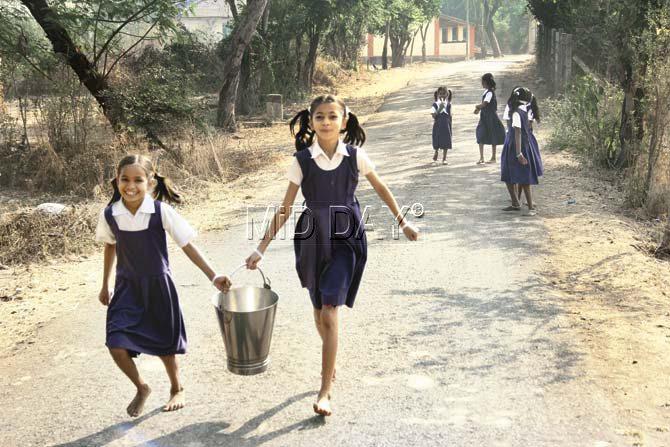 Girls carry water