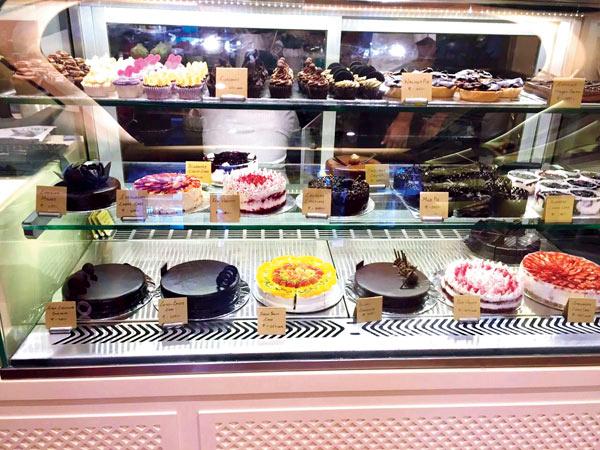 Shelves lined with cupcakes, pastries and cakes at Sugar Rush in Bandra