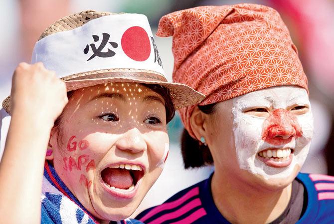 FIST UP: Japanese fans cheer their team in the Women’s Football World Cup