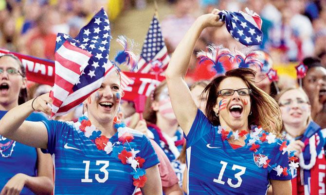 CHEER ON: US fans cheer on the team as they make the women’s football final. PIC/AP/PTI