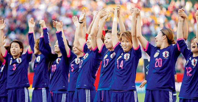 HERE WE GO: Japanese players acknowledge the crowd following their entry in the women’s football World Cup final where they will face USA