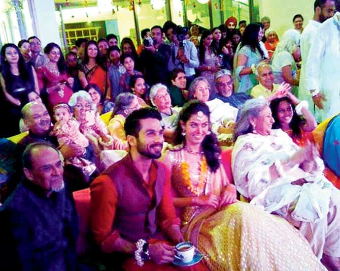 TUNING IN: Shahid and Mira seem visibly amused by a performance at their sangeet ceremony 