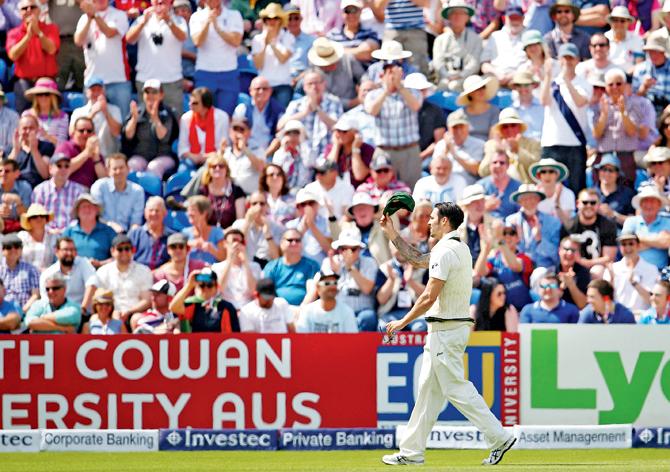 Australia pacer Mitchell Johnson doffs his cap after receiving a standing   ovation from England fans for his worst-ever bowling figures. PIC/GETTY IMAGES