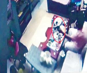 A screen grab of the CCTV footage , which shows the accused carrying a gun