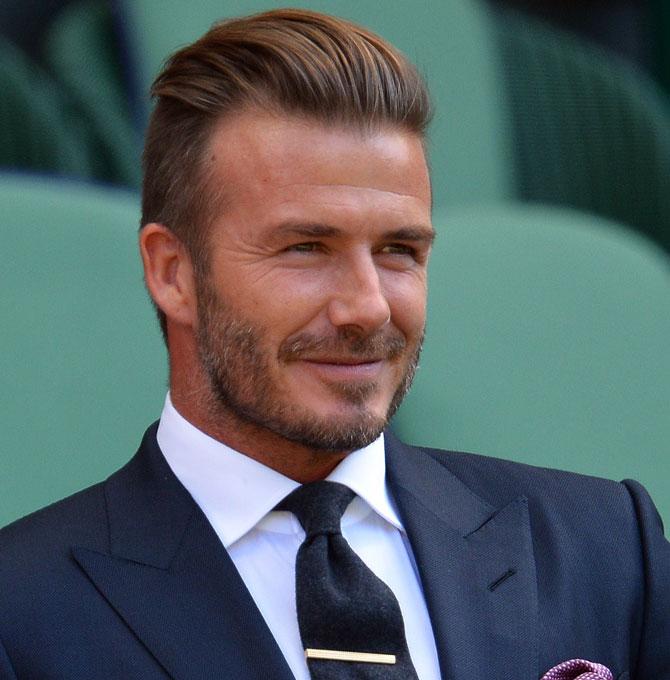 Wimbledon: David Beckham catches a stray shot while the crowd applauds