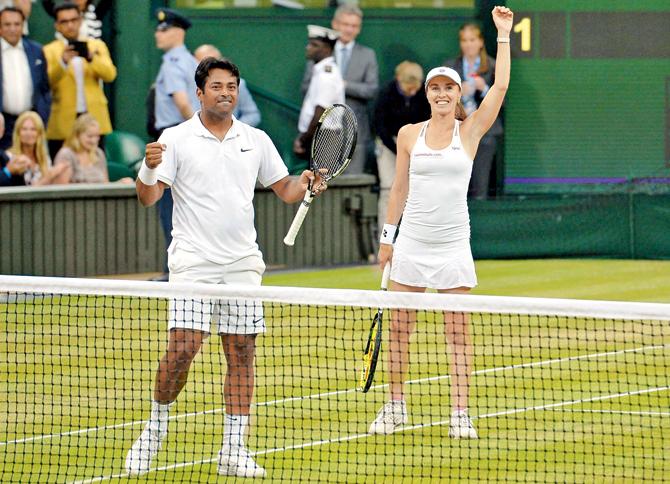 India’s Leander Paes (left) and Switzerland’s Martina Hingis celebrate after winning the Wimbledon mixed doubles final yesterday. Pic/AFP