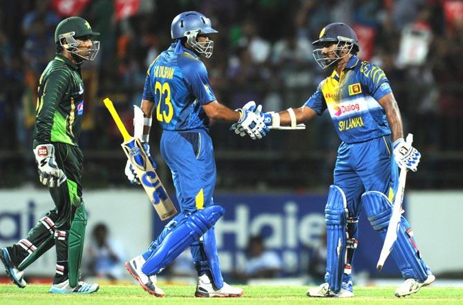 Sri Lankan cricketer Kusal Perera R is congratulated by teammate Tillekeratne Dilshan after scoring a half-century 50 runs during the second One Day International ODI match between Sri Lanka and Pakistan at the Pallekele International Cricket Stadium in Pallekele. Pic/AFP