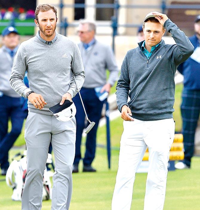 USA Dustin Johnson (left) and compatriot Jordan Spieth wait on the 18th green during their first rounds, on the opening day of the British Open Golf Championships at St Andrews, Scotland yesterday. Pic/AFP