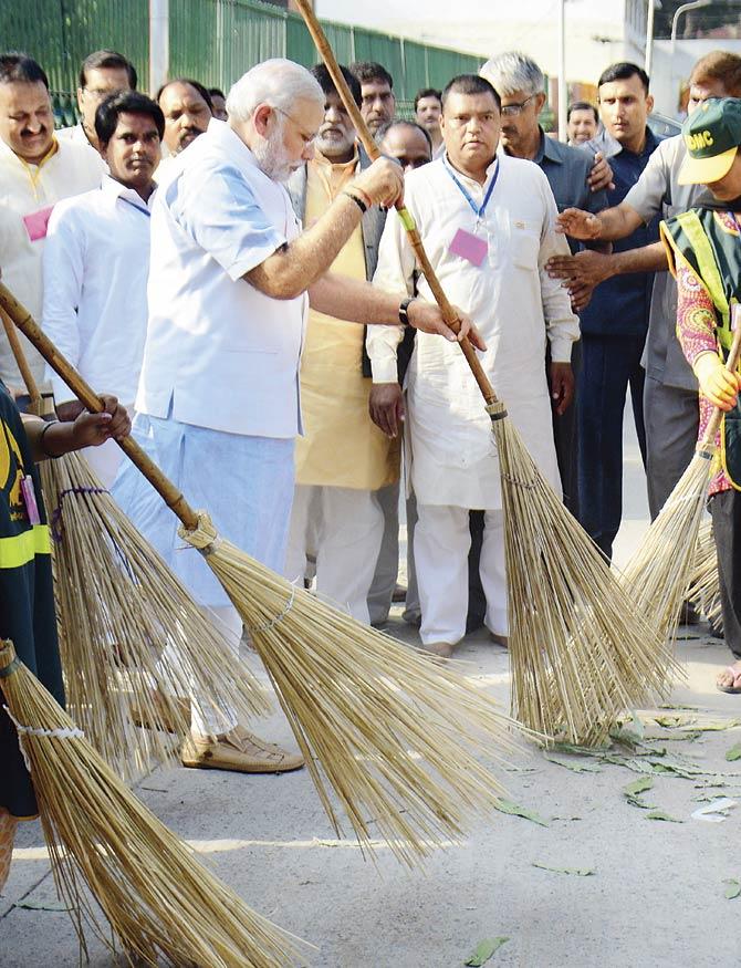 By symbolically sweeping a street on October 2, Modi triggered a mammoth rush of popular participation. Old and young, men and women, students and workers, peons and officers stepped forward to clean the spaces outside their homes, schools, colleges and offices. For the first time swachchata became the subject of popular discourse. Pic/AFP