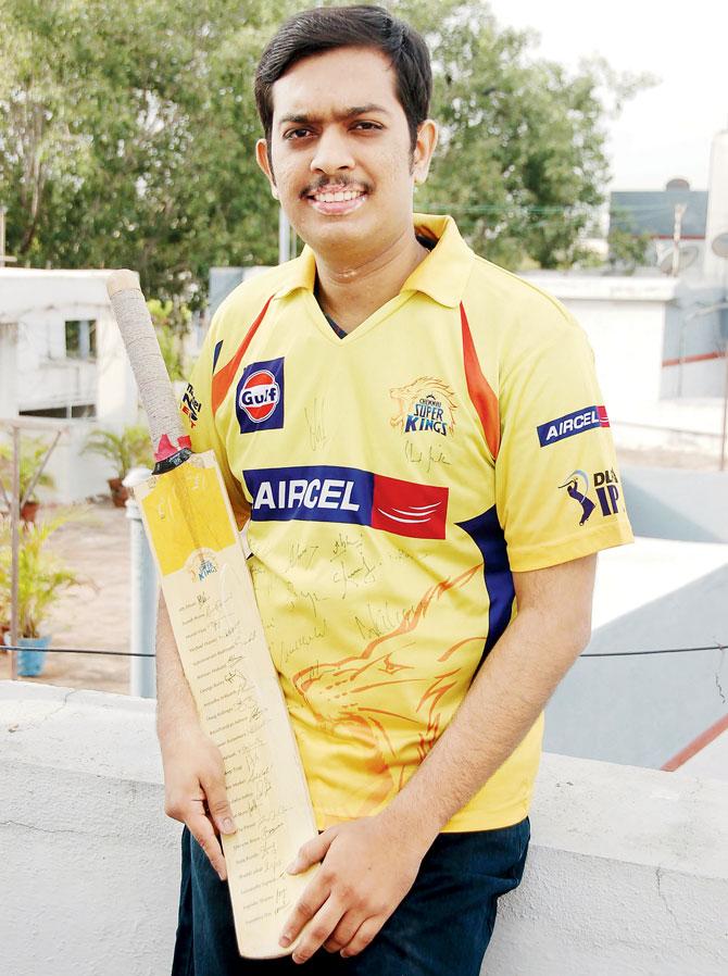 CSK fan Prashanth Prakasam wearing a jersey signed by the 2012 CSK squad and holding a bat autographed by the team at his residence in Chennai yesterday. PIC/Klik Ravi