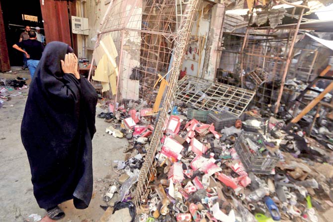 An Iraqi woman stands amid the debris in the aftermath of a massive suicide car bomb attack carried out by the Islamic State group in the predominantly Shiite town of Khan Bani Saad, Baghdad. Pic/afp 