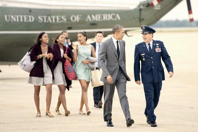 Obama and Sasha walk to Air Force One with her friends at Andrews Air Force Base in Maryland. Pics/afp