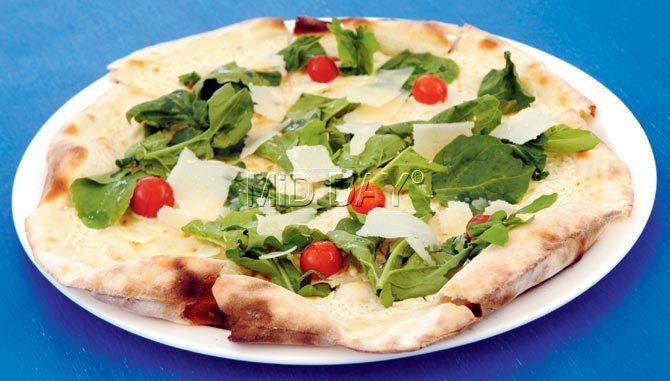 Biancaneve pizza, made with mascarpone, cherry tomatoes, rucola, parmesan flakes, truffle oil