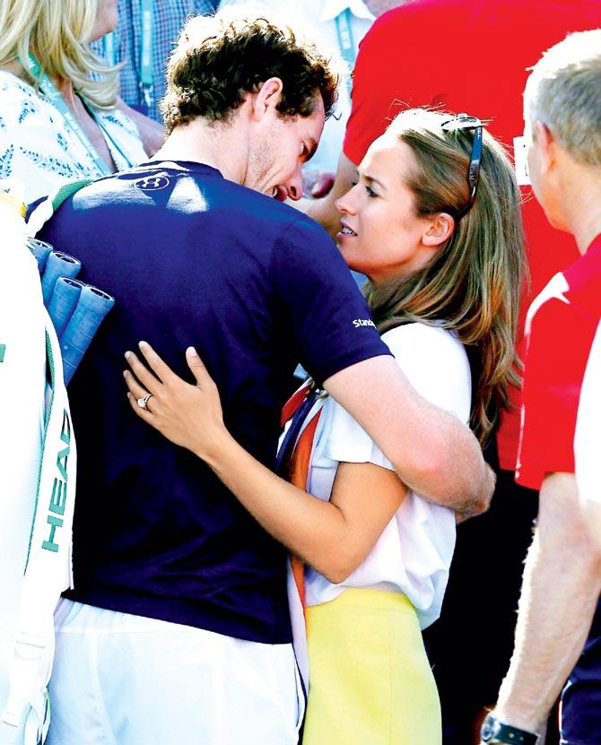 An emotional Andy Murray of Great Britain hugs wife Kim Sears after beating France
