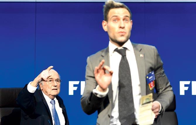 Brodkin speaks to journalists before preparing to shower Blatter with fake cash ahead of a press conference at FIFA headquarters yesterday