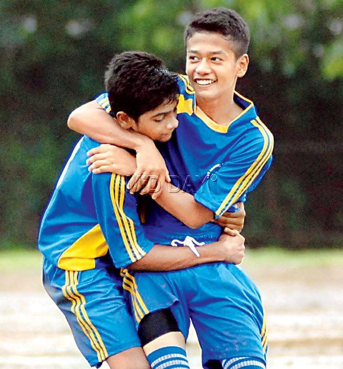 Krish Adhikari (right) and Kunal Patel of St Lawrence High School, celebrate a goal against St Mary