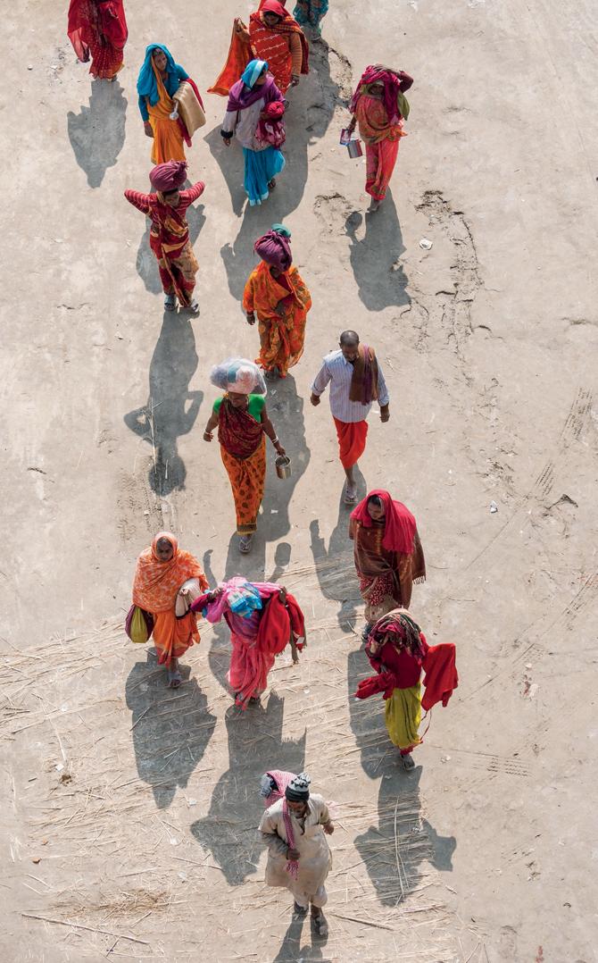 Pilgrims with their belongings walk through the mela streets, view from from atop the Shastri Bridge (Volume 2: History, Mythology, Belief).  Pics courtesy/ Anugraha