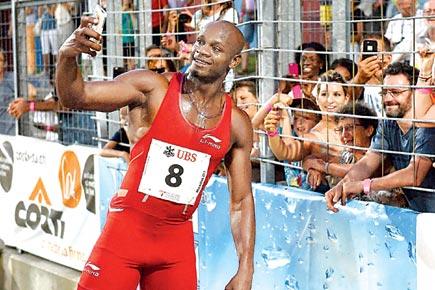 World Championships: Asafa Powell powers to victory