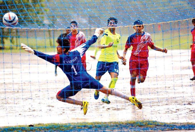 Michael Abhishek (green jersey) chips the ball into the Campion goal over goalkeeper Aryan Jhaveri at Azad Maidan. Pic/Atul Kamble