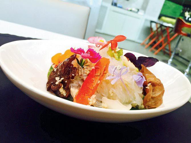 Yum Woon Sen, a spicy salad with glass noodles (with wheat protein, chicken and prawn options) comes garnished with petunia and passion flower petals, served at Lower Parel’s O:h Cha