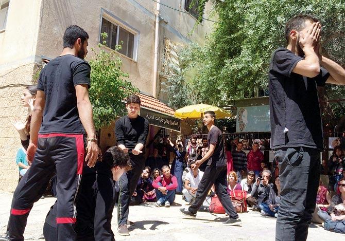 Students of The Freedom Theatre School perform a street play, titled The Occupation Machine, which they worked on during a two-day workshop with Sudhanva Deshpande. pics/Sudhanva Deshpande