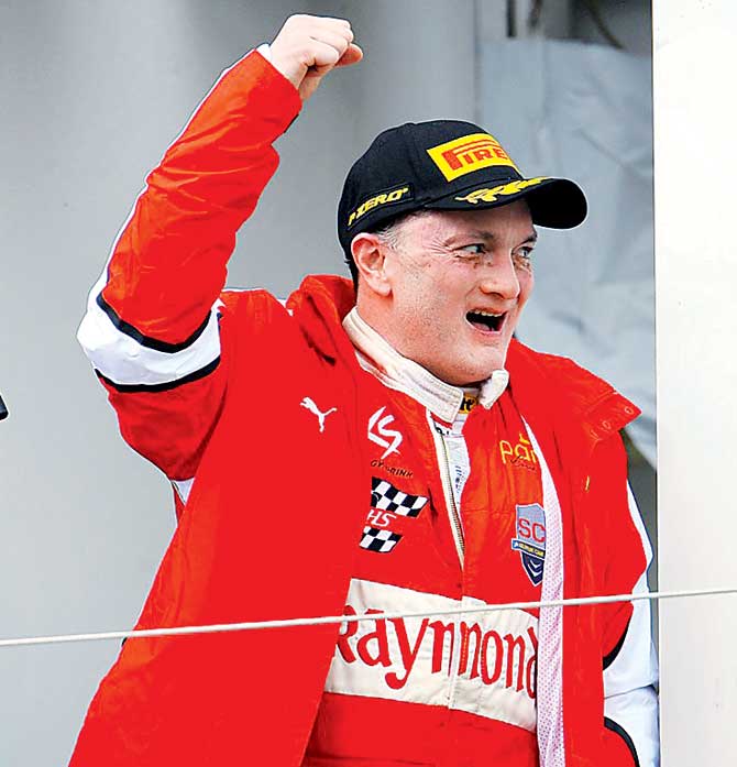 Gautam Singhania celebrates after finishing on the podium at the Ferrari Challenge Europe Championship 2015 at the Paul Ricard circuit in Le Castellet, France