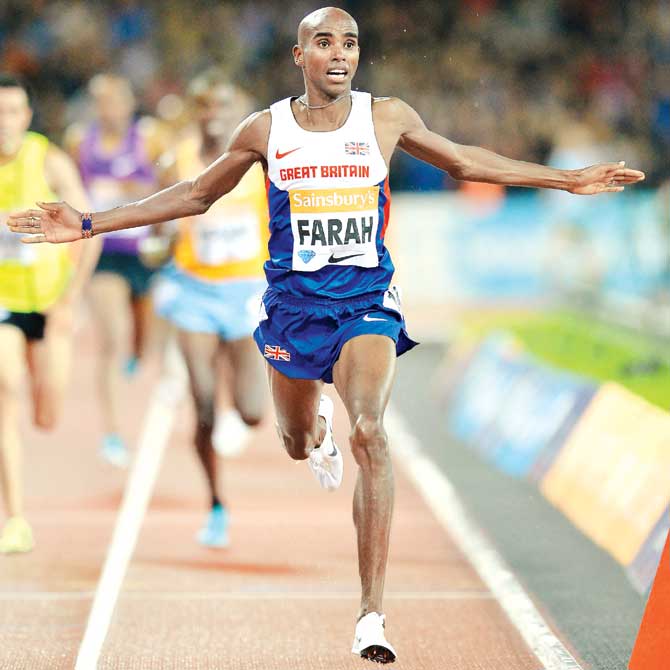 Mo Farah celebrates after crossing the finish line in the 3000m event. Pic/AFP