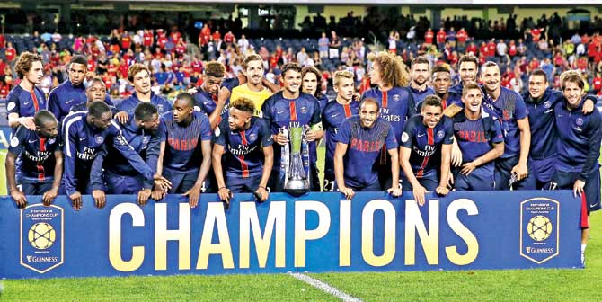 PSG players celebrate with the Champions Cup after beating Manchester United 2-0 at Chicago