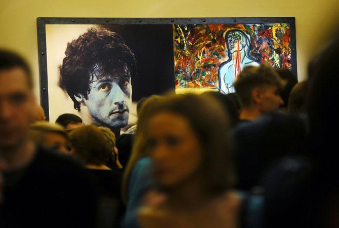 Visitors stand in front of the painting "Champion Due" by Sylvester Stallone during the art exhibition "Sylvester Stallone Painting From 1975 Until Today" at the Russian Museum in Saint Petersburg on October 27, 2013. Pic/AFP