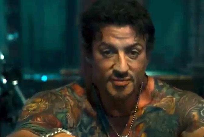Sylvester Stallone flaunts his tattoos in ‘The Expendables’. Pic/YouTube