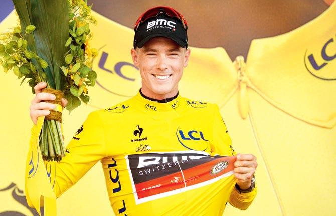 Rohan Dennis celebrates wearing the yellow jersey on Saturday