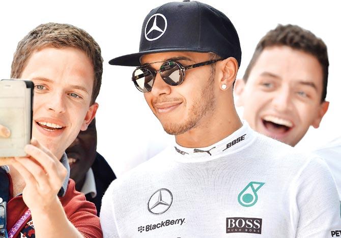 A fan takes a selfie with Lewis Hamilton after he clinches pole position at the British Grand Prix qualifying in Silverstone on Saturday. Pic/AFP