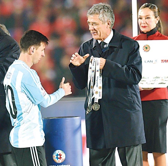 Off with it: In this series of pictures Argentina skipper Lionel Messi is first seen about to receive his second-place medal