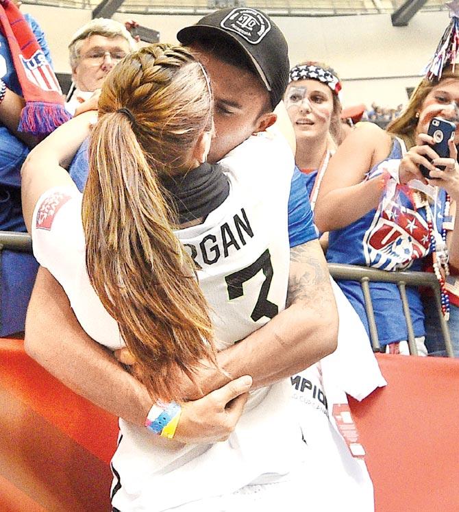 USA forward Alex Morgan is kissed by a friend after the victory over Japan in the Women