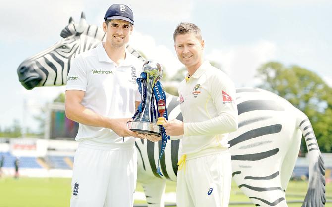 England captain Alastair Cook (left) and Australian skipper Michael Clarke pose with the Ashes trophy and urn in Cardiff yesterday. PIC/Getty Images