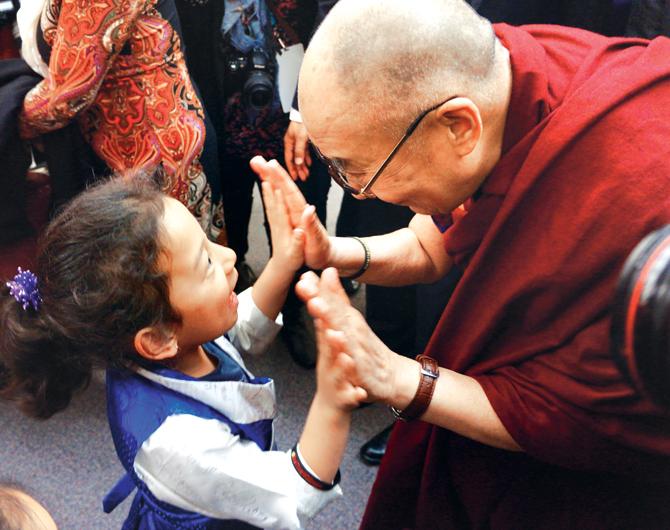 His Holiness greeting a young girl as he departs from John Oliver School in Vancouver, Canada