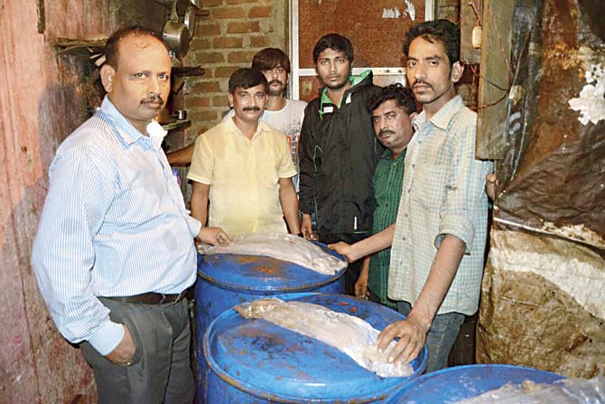 Eight drums of methanol had been recovered from prime accused Francis D’Mello’s (second from right) den, soon after the tragedy. File pic