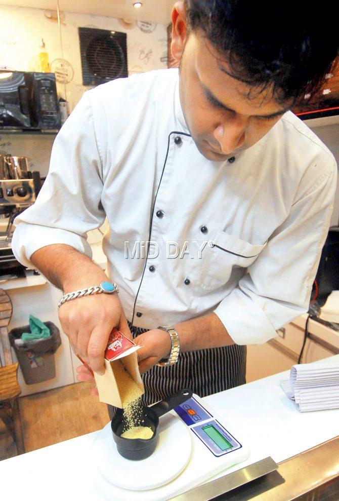 Head chef Abhishek Bhogte measures ingredients going into a Zone diet dish